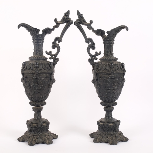 67 - Pair of 19th century cast-iron ornamental ewers, black painted finish, H44cm