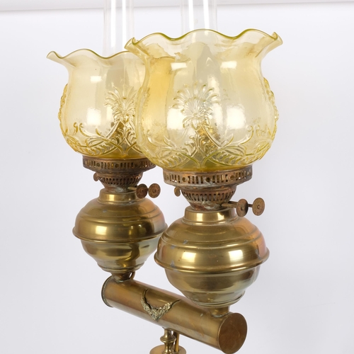 8 - A Victorian brass double oil lamp, with original moulded uranium glass shades and funnels, converted... 