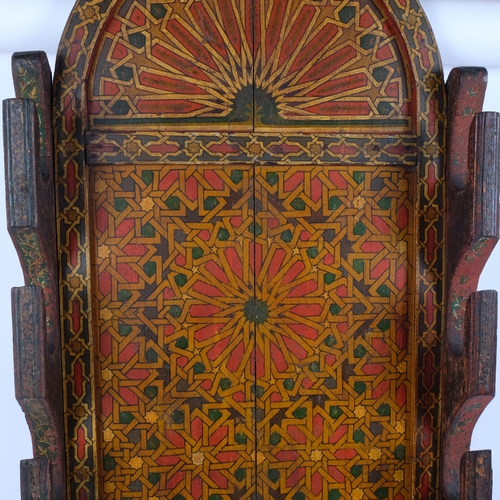 96 - A Moroccan wall-mounted gun rack, with painted geometrical decoration, H95cm