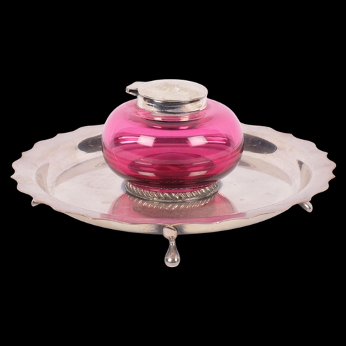 550 - An Antique silver plated cranberry glass desk inkstand, base diameter 18cm