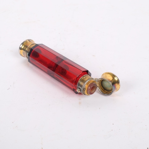 579 - SAMPSON MORDAN & CO - a Victorian silver-gilt ruby glass double-ended scent bottle, with screw and p... 