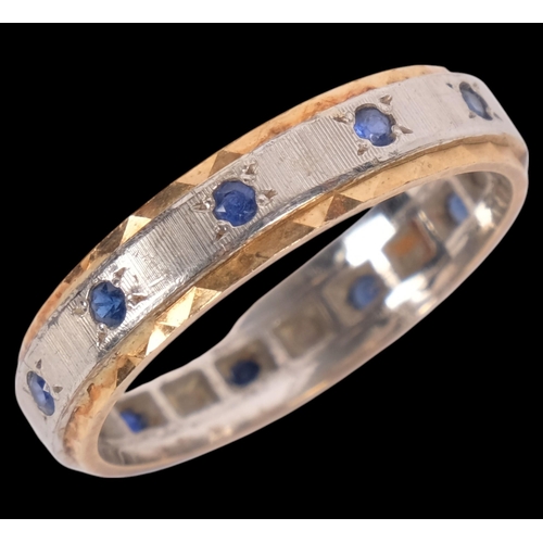 596 - A 9ct two-colour gold sapphire full eternity ring, Birmingham 1975, size Q, 3.5g