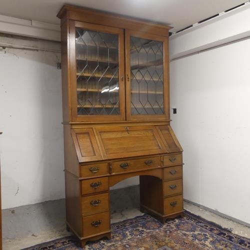 2313 - A early 20th Century oak two section bureau bookcase. Top section with two lead-light glazed doors. ... 