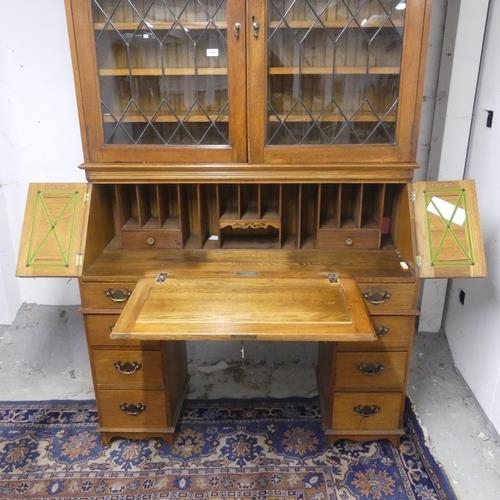 2313 - A early 20th Century oak two section bureau bookcase. Top section with two lead-light glazed doors. ... 