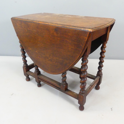 2357 - An early 20th century oak oval gate-leg drop-leaf table with barley twist supports. Width 89cm, heig... 