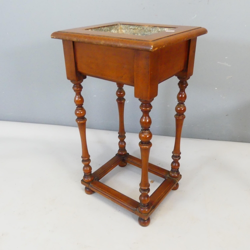 2358 - A mahogany plant stand, with galvanised metal lining, raised on turned legs with all around stretche... 