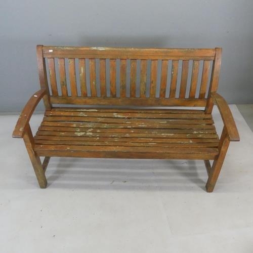 2361 - A weathered slatted teak garden bench. Length 138cm, height 93cm, width 64cm.