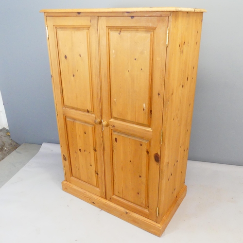 2362 - A compact modern pine two-door wardrobe, with hanging rail and three shelves. Width 90cm, height 140... 