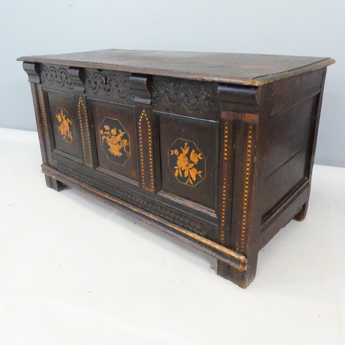 2402 - An 1th century oak blanket box, with carved and marquetry inlaid decoration and raised on stile legs... 