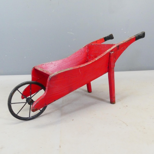 2428 - A small antique hand made wheelbarrow. Length 90cm.