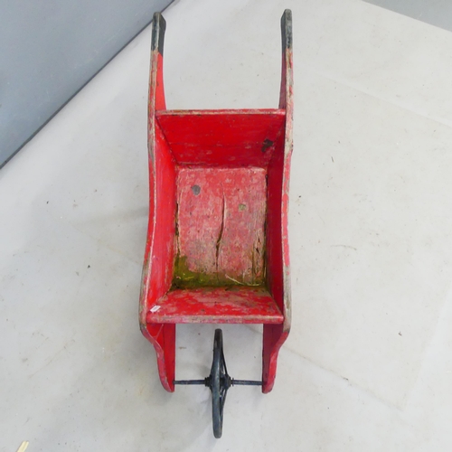 2428 - A small antique hand made wheelbarrow. Length 90cm.