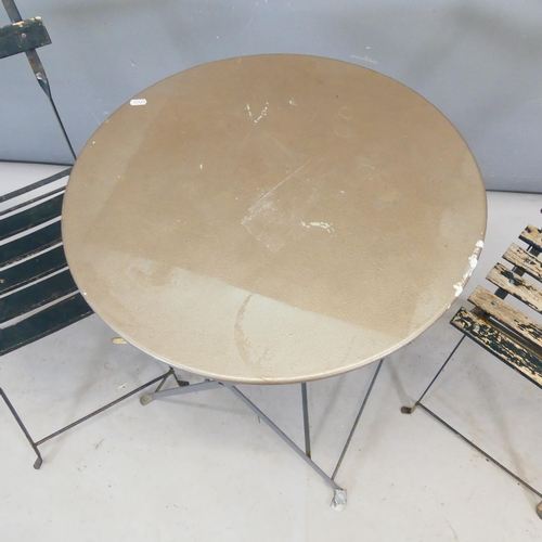 2432 - A pair of French Parisienne folding bistro chairs, and a metal circular topped folding table, diamet... 