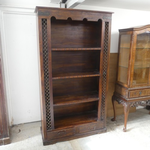 2511 - A modern Indonesian hardwood open bookcase, with metal mounts and inset panels, fixed shelves and dr... 