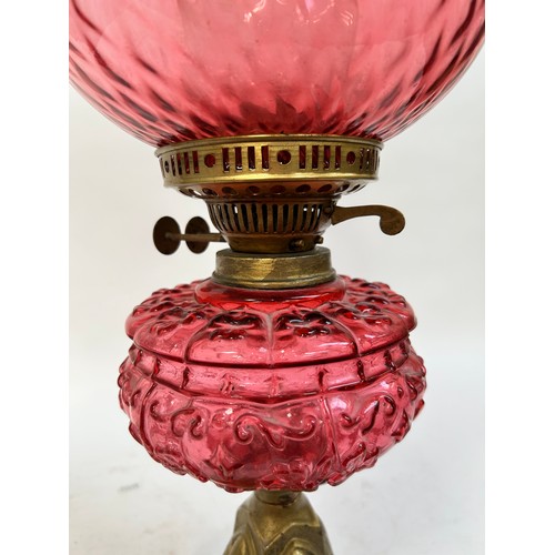 20 - A Victorian Duplex brass cranberry glass oil lamp, with original moulded cranberry glass shamrock fo... 