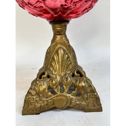 20 - A Victorian Duplex brass cranberry glass oil lamp, with original moulded cranberry glass shamrock fo... 