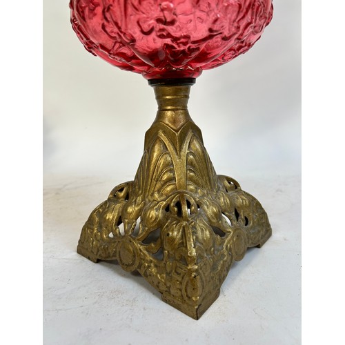 20 - A Victorian Duplex brass cranberry glass oil lamp, with original moulded cranberry glass shamrock fo... 