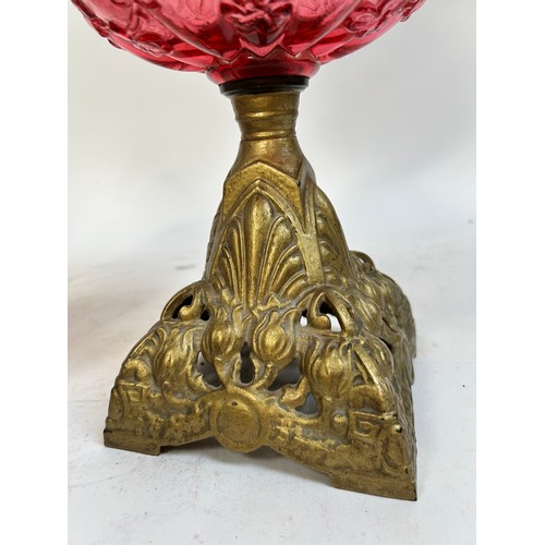 20 - A Victorian Duplex brass cranberry glass oil lamp, with original moulded cranberry glass shamrock fo... 