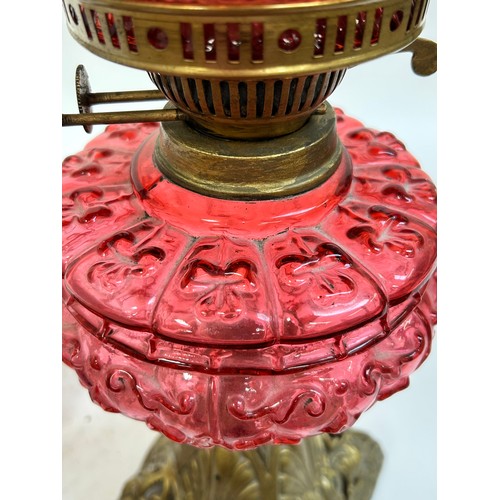 20 - A Victorian Duplex brass cranberry glass oil lamp, with original moulded cranberry glass shamrock fo... 