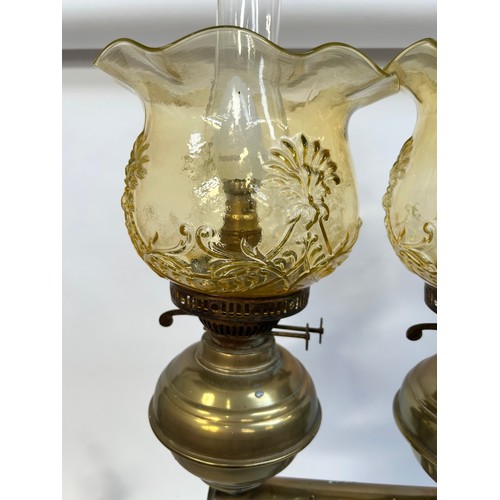 8 - A Victorian brass double oil lamp, with original moulded uranium glass shades and funnels, converted... 