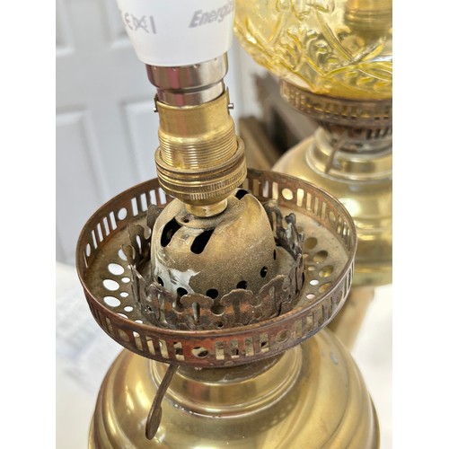 8 - A Victorian brass double oil lamp, with original moulded uranium glass shades and funnels, converted... 