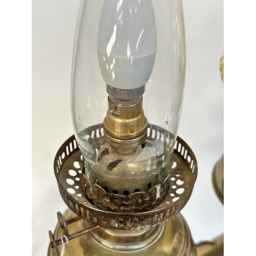 8 - A Victorian brass double oil lamp, with original moulded uranium glass shades and funnels, converted... 