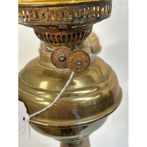 8 - A Victorian brass double oil lamp, with original moulded uranium glass shades and funnels, converted... 