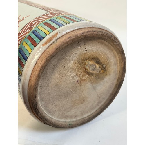 135 - A Chinese famille vert ceramic barrel stick stand, 45cm
