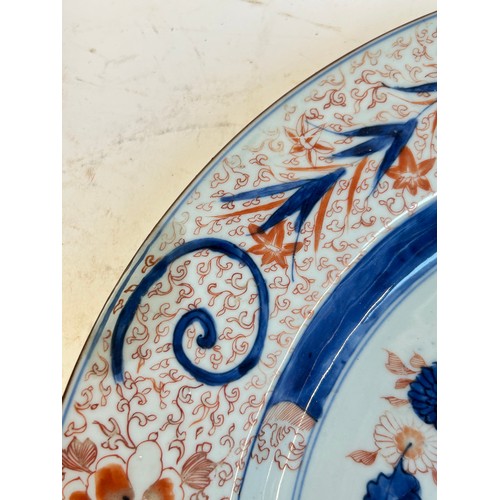 145 - A Chinese red blue and gilt decorated porcelain plate, diameter 39cm, and a Japanese blue ground pla... 