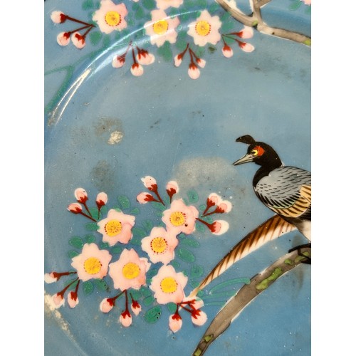 145 - A Chinese red blue and gilt decorated porcelain plate, diameter 39cm, and a Japanese blue ground pla... 