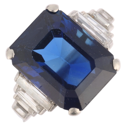 An Art Deco No Heat sapphire and diamond ring, the octagonal step-cut sapphire weighing approximately 7.65ct, and flanked by 8 graduated baguette-cut diamonds, unmarked mount tests as platinum, setting height 12.4mm, size Q, 4.7g