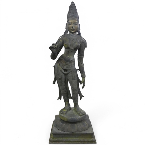 A large and impressive patinated bronze statue of the Hindu Goddess Parvati, with ornately detailed decoration and raised on stepped pedestal base. Overall height 140cm.