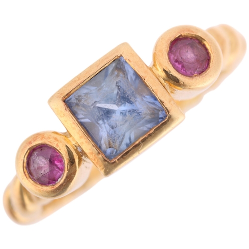 An 18ct gold three stone sapphire and ruby ring, rub-over set with ...