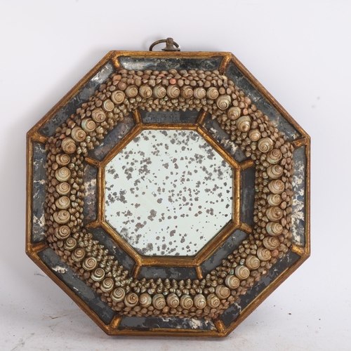 A small Victorian octagonal shellwork decorated wall mirror, the ...