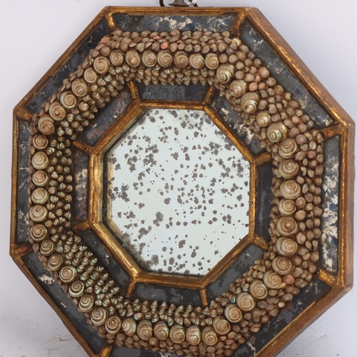 A small Victorian octagonal shellwork decorated wall mirror, the ...