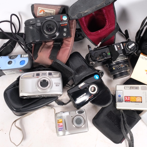 A group of various cameras, including an Olympus Multi AF Superzoom, an ...