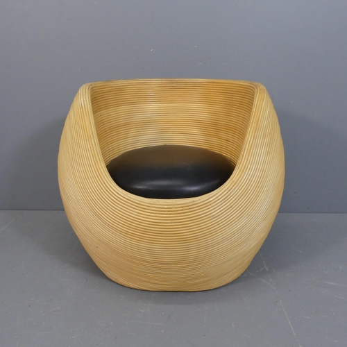 A contemporary rattan tub chair in the manner of Gabriella Crespi, the faux-leather upholstered seat lifting off to reveal a storage compartment. Overall width approximately 90cm, height 73cm, depth 76cm.