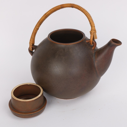 32 - An Arrabia GA3 model tea pot with cane handle, height 20cm