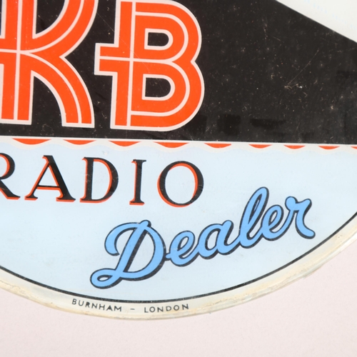 37 - A 1950s' glass advertising sign for KB Radio, with the Queen Elizabeth II ocean liner, diameter 29cm