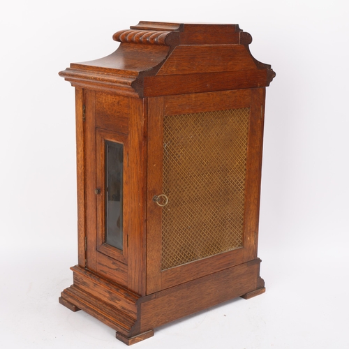 307 - A carved oak-cased 8-day mantel clock, with engraved silvered dial and brass 8-day movement chiming ... 
