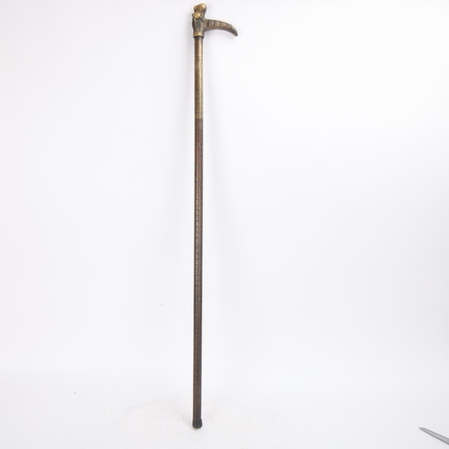 325 - A Chinese bronze walking cane with figural handle, the bronze shaft decorated with figures and text,... 