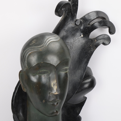 335 - An Art Deco carved stained wood stylised head, in the manner of Margarete Moll, with carved and pain... 