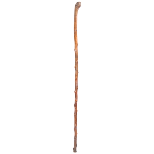 338 - A 19th century Folk Art Blackthorn walking cane, finely engraved with naive figures, lovers building... 