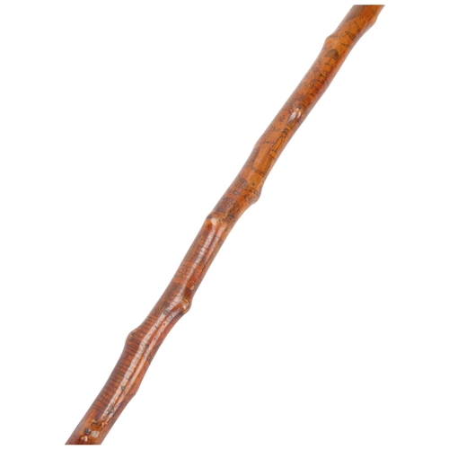 338 - A 19th century Folk Art Blackthorn walking cane, finely engraved with naive figures, lovers building... 
