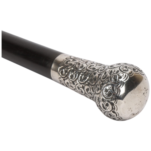 343 - An Edwardian ebony walking cane, with large embossed silver top, hallmarks London 1910