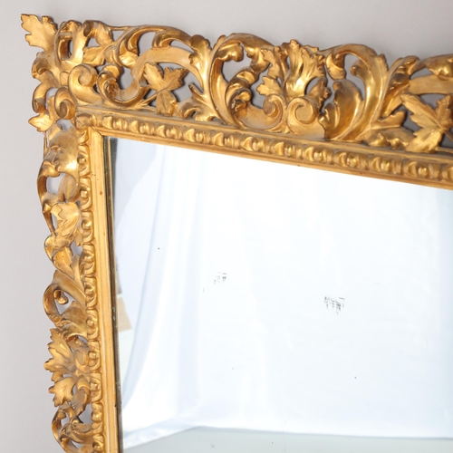 355 - A 19th century Florentine carved and pierced giltwood-framed wall mirror, in acanthus surround, over... 