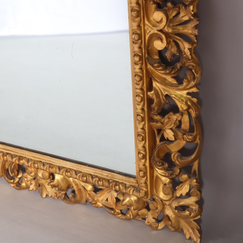 355 - A 19th century Florentine carved and pierced giltwood-framed wall mirror, in acanthus surround, over... 