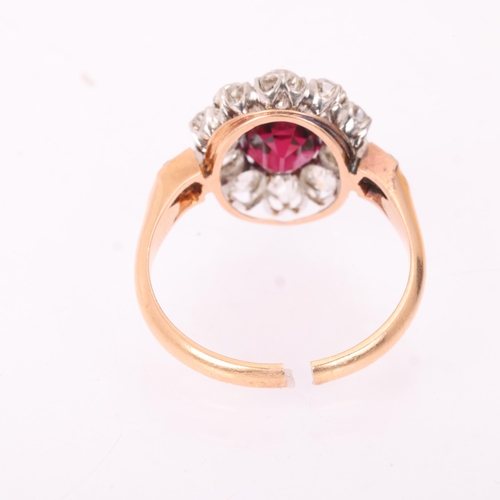 1120 - A fine 18ct gold ruby and diamond cluster ring, claw set with 2.5ct oval mixed-cut ruby surrounded b... 