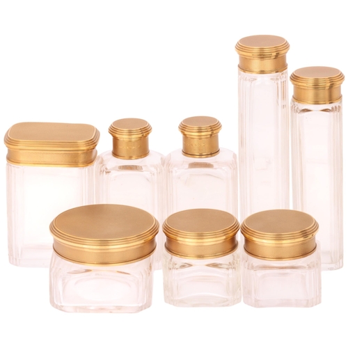 1124 - ASPREY - an Art Deco 18ct gold mounted glass 8-piece dressing table toilet jar set, London 1929, com... 