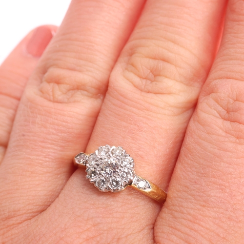 1324 - An 18ct gold diamond cluster ring, set with modern round brilliant-cut diamonds, total diamond conte... 
