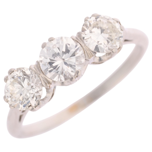 1326 - A platinum three stone diamond ring, claw set with modern round brilliant and transitional-cut diamo... 